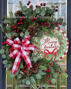 a christmas wreath with pine cones and berries