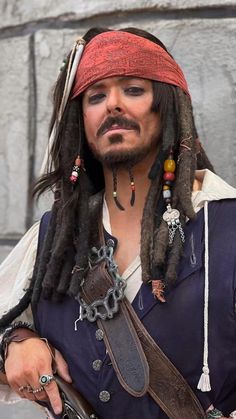 a man with dreadlocks wearing a pirate costume