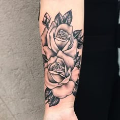 a woman's arm with a rose tattoo on it