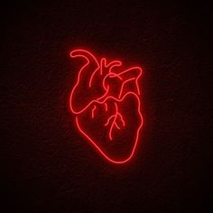 a red neon heart on a black wall