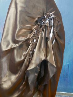 This elegant golden bronze satin skirt has a 1.25-inch (3.18cm) waistband that closes in the back with a 6-inch (15.24cm) zipper and button. The stunning formal skirt has two layers of bronze satin, with a floral cluster decorated lifted gather on the center-left hip that creates cascading soft goddess folds on the front of the skirt. The skirt has an ivory cream-colored underskirt that peeks out from the center front. Waist = 26.5 inches (67.31cm) Hips = 37 inches (93.98cm) Skirt Length = 42 in Satin Long Skirt, Dark Magenta, Formal Skirt, 1960s Fashion, European Vintage, Satin Skirt, Formal Style, Tartan Pattern, Vintage Summer