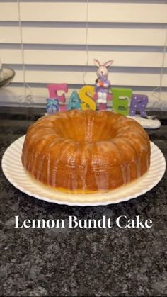 a lemon bundt cake sitting on top of a counter next to a plastic easter bunny sign