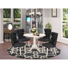 a white table with four black chairs around it