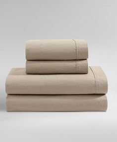 the sheets are folded and ready to be used in this bedding set, which is light beige