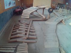 several pieces of wood sitting on top of a wooden floor in a room with walls