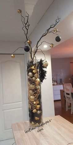 a vase filled with ornaments on top of a wooden table