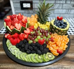 a platter filled with different types of fruit