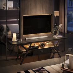 a living room with a large flat screen tv mounted on the wall above a wooden entertainment center