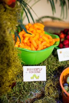 there are many different fruits and vegetables in bowls on the table, including carrots