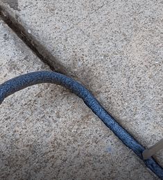 a close up of a blue cord on the ground