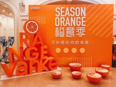 there are oranges on display in front of an orange sign that says season orange