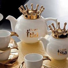 a gold and white tea set on a table