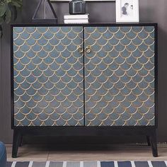 a blue and gold patterned cabinet in a living room