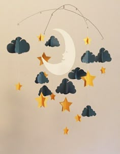 a mobile with stars and clouds hanging from it