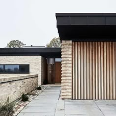 a brick building with wooden slats on the front door and side walk leading up to it