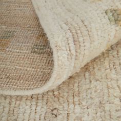 a close up view of a rug on the floor with an area rug that looks like it has been cleaned