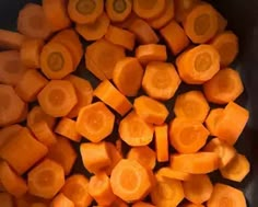 sliced up carrots in a black bowl on a table