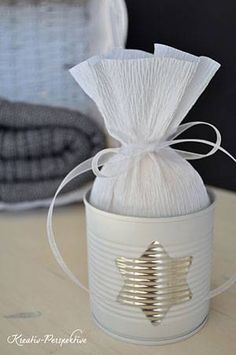 a white canister with a string wrapped around it and a star on the side