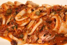 pasta with meat and sauce on a white plate