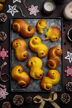 a tray filled with pastries sitting on top of a table next to christmas decorations