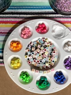 there are many beads in the tray on the table