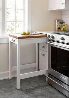 a kitchen with an oven, counter and window