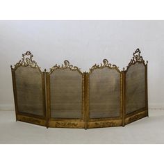 an ornately decorated room divider with four panels