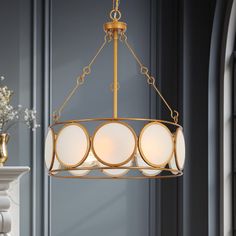 a chandelier hanging from the ceiling in a room with blue walls and white trim