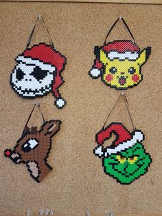 four pixelated christmas ornaments hanging on a wall