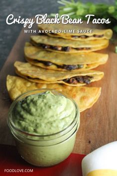 some tortilla chips and guacamole on a cutting board