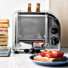 toasters stacked on top of each other with sandwiches in front of them