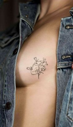 a woman with a tattoo on her chest and breast is shown in the shape of a flower