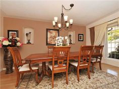 a dinning room table with chairs and a chandelier