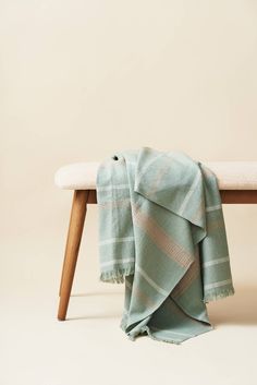 a blanket sitting on top of a wooden bench