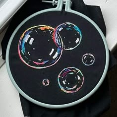 a black cloth with some colorful bubbles on it