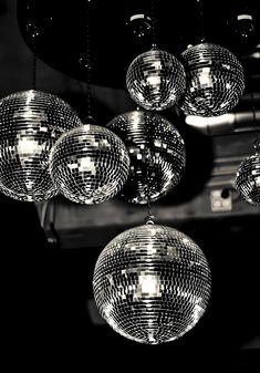 disco balls hanging from the ceiling in black and white