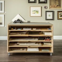 a book shelf with many books and pictures on the wall