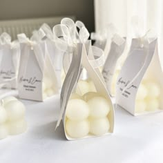 small bags filled with white candies on top of a table