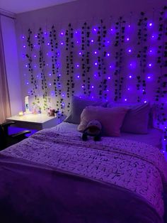 a bedroom with purple lights on the wall