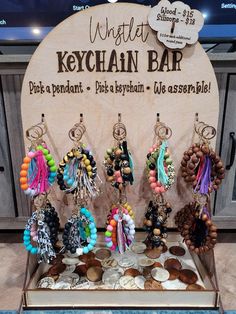 the keychain bar is set up with lots of different bracelets and earrings