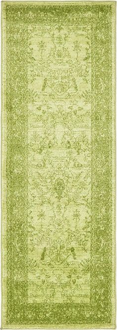 an area rug with green and yellow colors on the floor, including a border in the middle