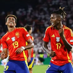 two men in red and yellow soccer uniforms