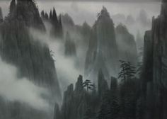 the mountains are covered in fog and mist, with pine trees on each one side