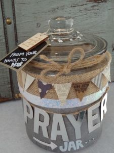 a glass jar with a label on it that says pray and is decorated with bunting