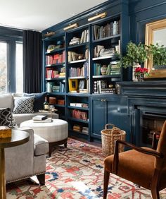 a living room filled with lots of furniture and bookshelves next to a fire place