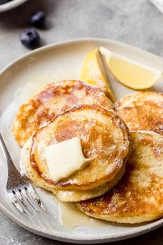 pancakes on a plate with butter and blueberries