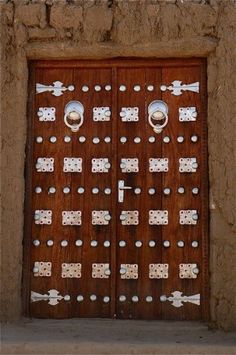 an old door with metal decorations on it