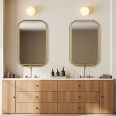 two mirrors on the wall above a double sink