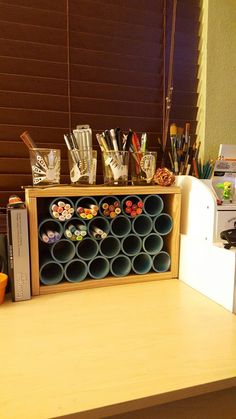 a kitchen counter with cups and utensils sitting on it's shelf next to an appliance