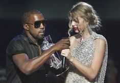 a man and a woman standing next to each other holding microphones in their hands